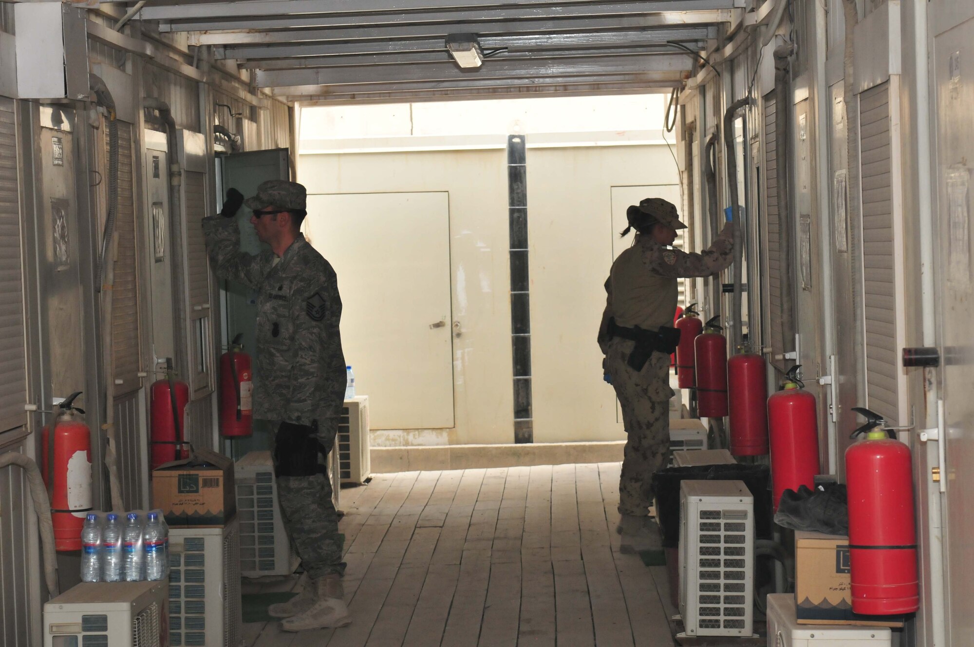 U.S. and coalition International Security Assistance Forces Military Police conduct a compound sweep on the morning of May 26. Once the compound is entered and secured all occupants are escorted out of their rooms. Contraband checks are then conducted by fire teams led by experienced IMP members. These teams are made up of many nationalities all working together to ensure base protection. (U.S. Photo by Army Capt Andrew Adcock)