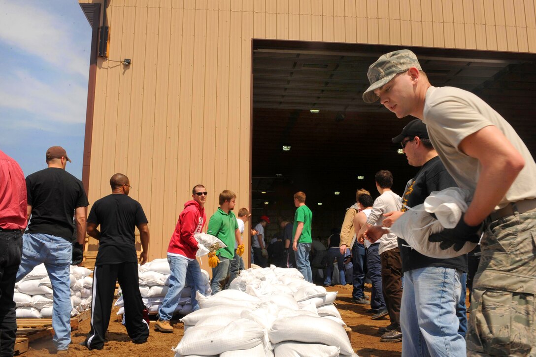 Water rises toward the top of the river bank along the Souris River in