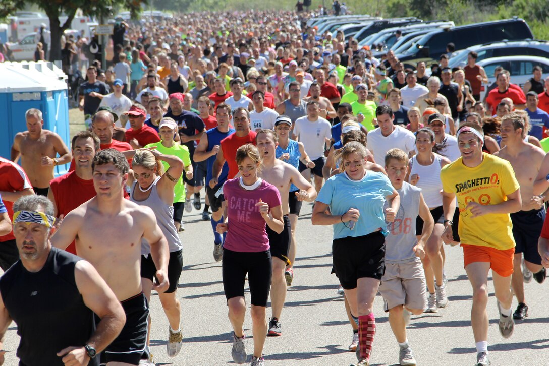 Participants of Marine Corps Community Service's "World Famous Mud Run," sponsored by U.S. Marine Corps Forces, Special Operations Command, take off from the starting line June 4, 2011. The 10k race is part of MCCS's Hard Corps Race Series. (Official U.S. Marine Corps photo courtesy of Monroe photography/Released)