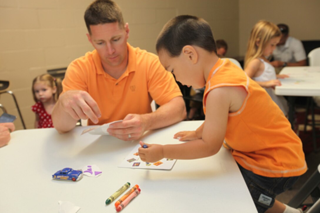 A father and son participate in arts and crafts during the Father’s Day Brunch provided by the Harriotte B. Smith Library and Tarawa Terrace Community Center, aboard the Marine Corps Base Camp Lejeune housing area, June 4. For the third year in a row, the brunch gave children and their fathers a chance to spend quality time with one another.