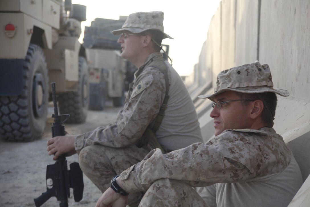 Navy Lt. Stephen DiCenso (right) and Petty Officer 3rd Class Matthew Gallagher wait at Camp Leatherneck for a convoy bound for Forward Operating Base Delaram, Afghanistan, June 4. DiCenso is the chaplain for Marine Wing Support Squadron 272, and Gallagher is a religious programs specialist with in the same unit.