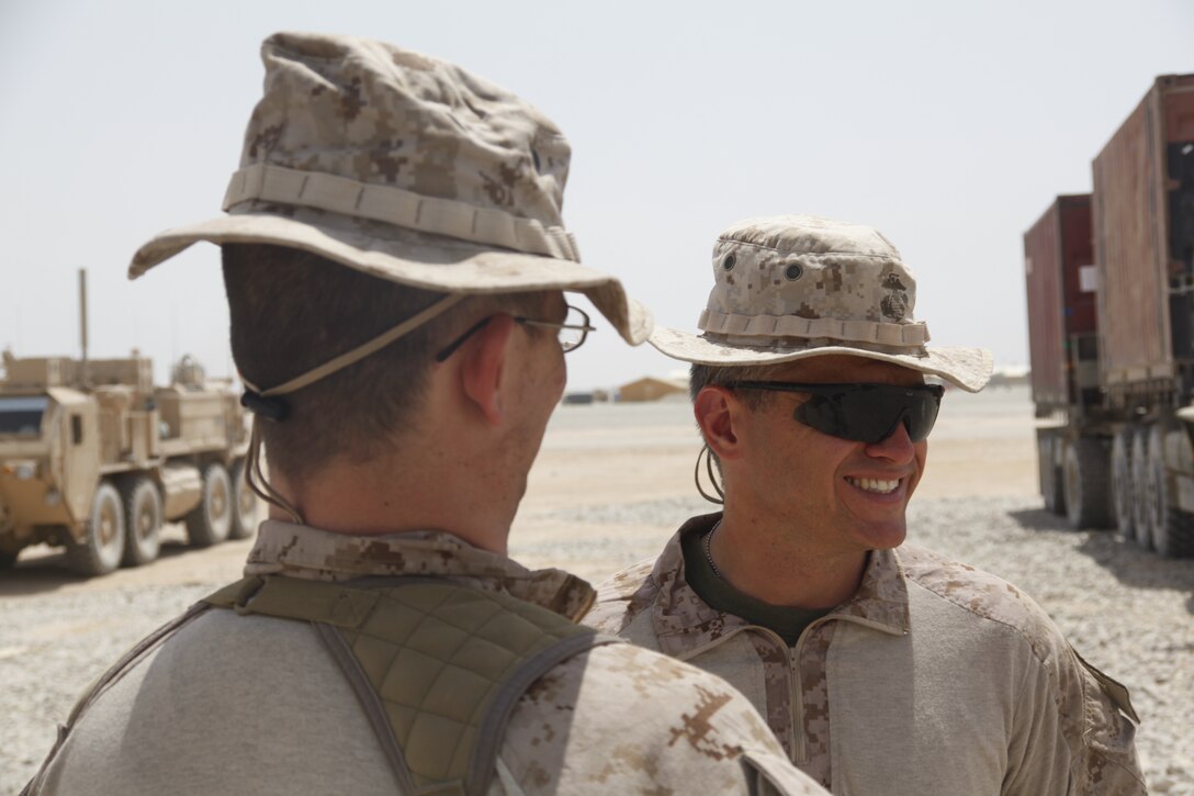 Petty Officer 3rd Class Matthew Gallagher , left,  and Navy Lt. Stephen DiCenso wait to greet Marines at Forward Operating Base Delaram, Afghanistan, June 4. DiCenso is the chaplain for Marine Wing Support Squadron 272, and Gallagher is a religious programs specialist with in the same unit.