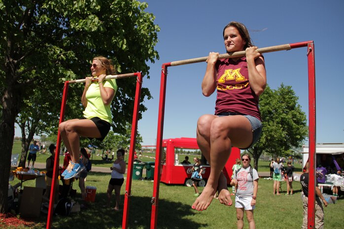 Debbie Stenoien, (right) a scrumhalf and flyhalf for the University of Minnesota women’s rugby team, and a fellow rugby enthusiast from Burnsville, Minn., take the flexed-arm hang challenge while attending the Minnesota Amateur Rugby Foundation Tournament June 4 at the National Sports Center. Several players from the school's rugby club volunteered to help at the tournament. For additional imagery from the event, visit www.facebook.com/rstwincities.