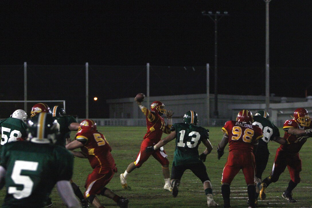Sanford James, Camp Foster Bulldogs  quarterback, attempts a pass against the Joint Task Force Wolfpack at Camp Foster June 4.