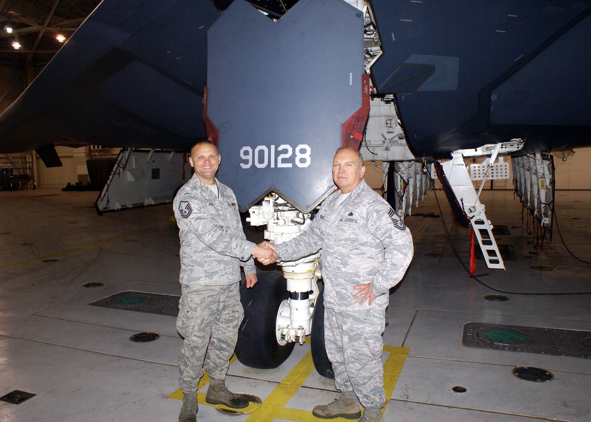 Master Sgt. Craig Kuzara is congratulated by Chief Master Sgt. Steven Rolwes on Kuzara's appointment as the first Air National Guardsman Dedicated Crew Chief (DCC) for a B-2 aircraft.  Kuzara will be DCC for the "Spirit of Nebraska."  Kuzara and Rolwes are members of the 131st Bomb Wing Maintenance Group, Missouri Air National Guard at Whiteman AFB.  (Photo by Chief Master Sgt. Dan Peters) 