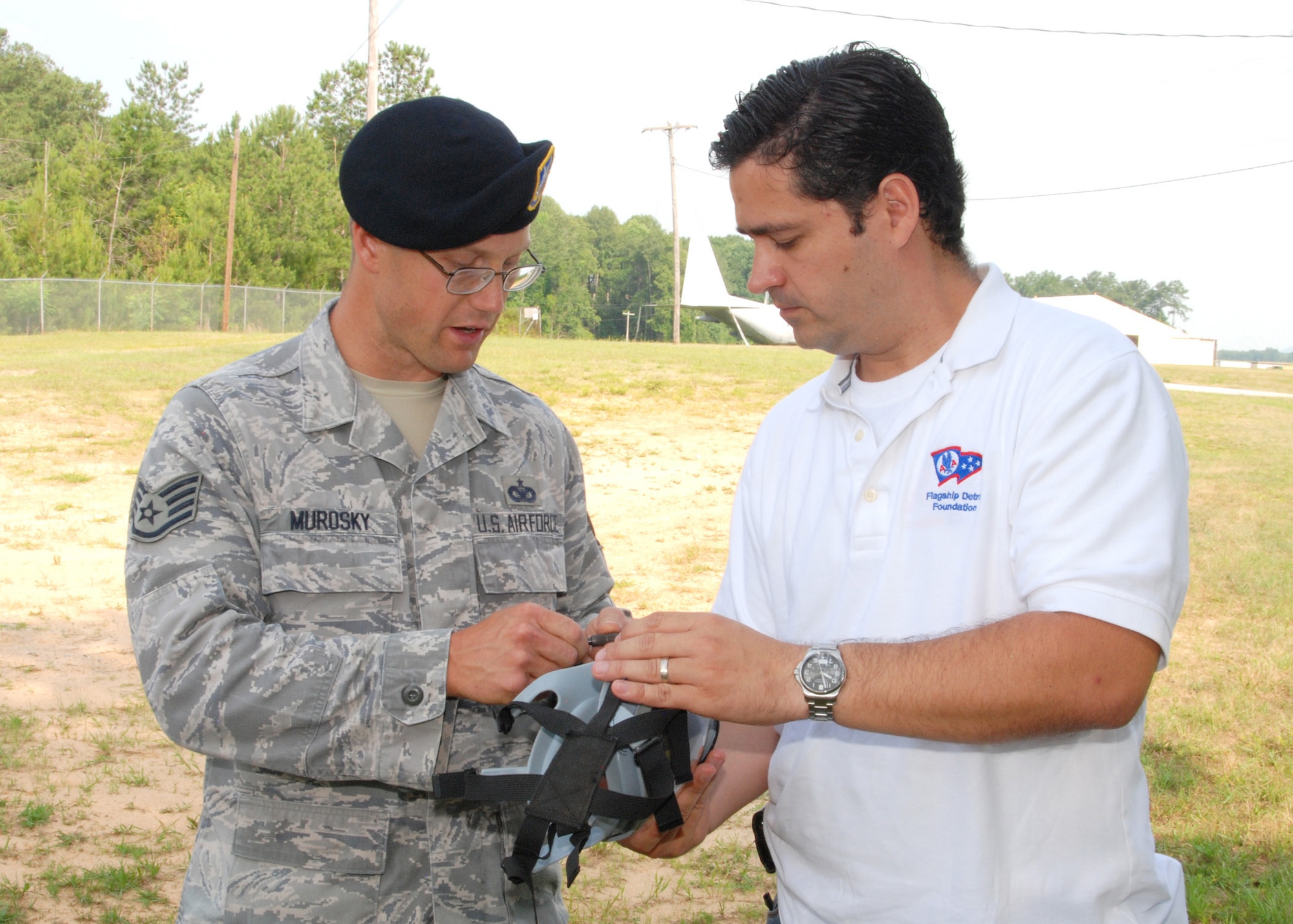 Staff Sgt. Stephen Murosky, 94th Security Forces Squadron patrolman, briefs Mr. Juan Liscano, a visiting employer on the details of a MCU-2/P gas mask.  Each year at Dobbins Air Reserve Base employers of reservists are invited to visit and learn about their employee's participation in the United States Air Force Reserve.  (U.S. Air Force photo/Master Sgt. Stan Coleman)