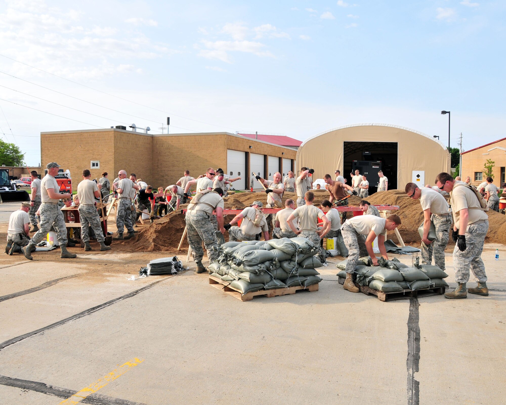 Members of the 185 Air Refueling Wing, Sioux City, Iowa, build a wall of sandbags around the main hanger in preperation for the flooding of the Missouri River.