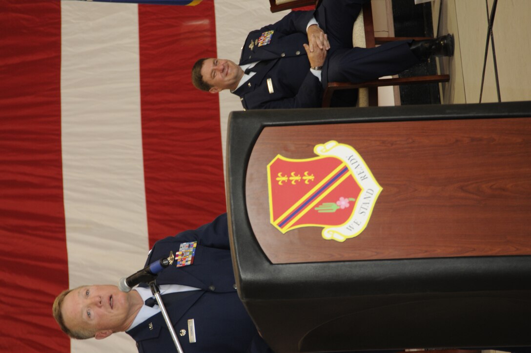 Col. Michael T. Thomas addresses the 1,700 Citizen-Airmen of the 127th Wing at Selfridge Air National Guard Base, Mich., just moments after taking command of the wing. Thomas, a KC-135 pilot, replaces Brig. Gen. Michael L. Peplinski, seated, who retired after more than 32 years of military service. (U.S. Air Force photo by TSgt. David Kujawa)