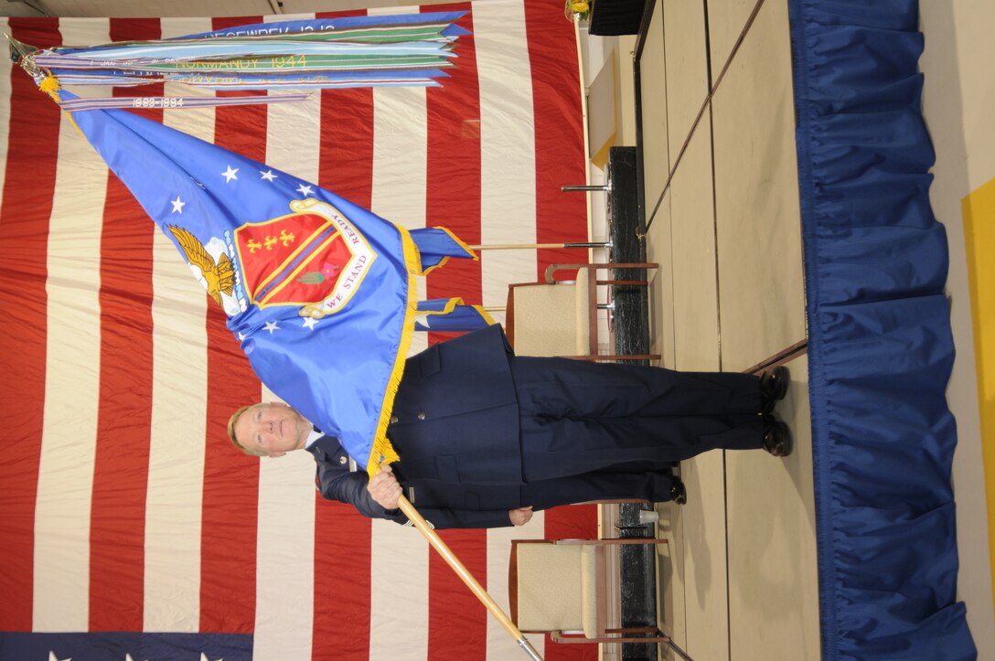 Col. Michael T. Thomas holds the 127th Wing flag moments after taking command of the wing in a ceremony at Selfridge Air National Guard Base, Mich., June 4, 2011. Military commanders hold aloft the unit flag for all to see in a ceremony that traces its roots back to the days when kings lead their soldiers into battle in the field and the troops would follow the commands of he who held the flag. The streamers on the top of the flag represent deployments and battles that the wing has participated in over the years. (U.S. Air Force photo by TSgt. David Kujawa)