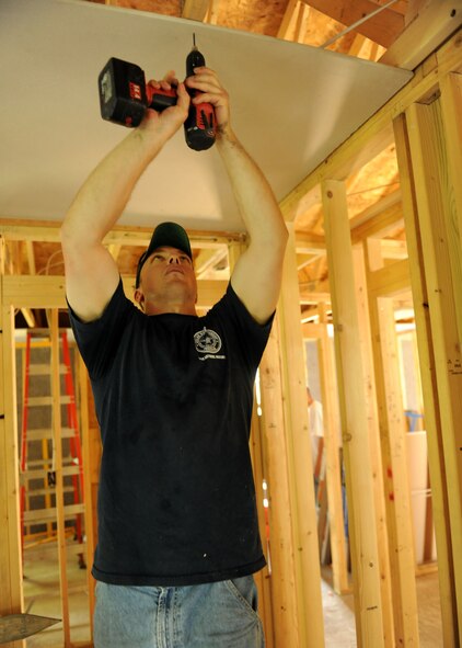 U.S. Air Force Technical Sgt.  Chris Ferguson is putting up sheetrock at a “Habitat for Humanity” home in Syracuse, NY on 26 May 2011.  Ferguson and other members of the 174th Fighter Wing took part in a volunteer opportunity with Lockheed Martin to help “Habitat for Humanity”. (U.S. Air Force photo by Staff Sgt. Ricky Best/RELEASED)