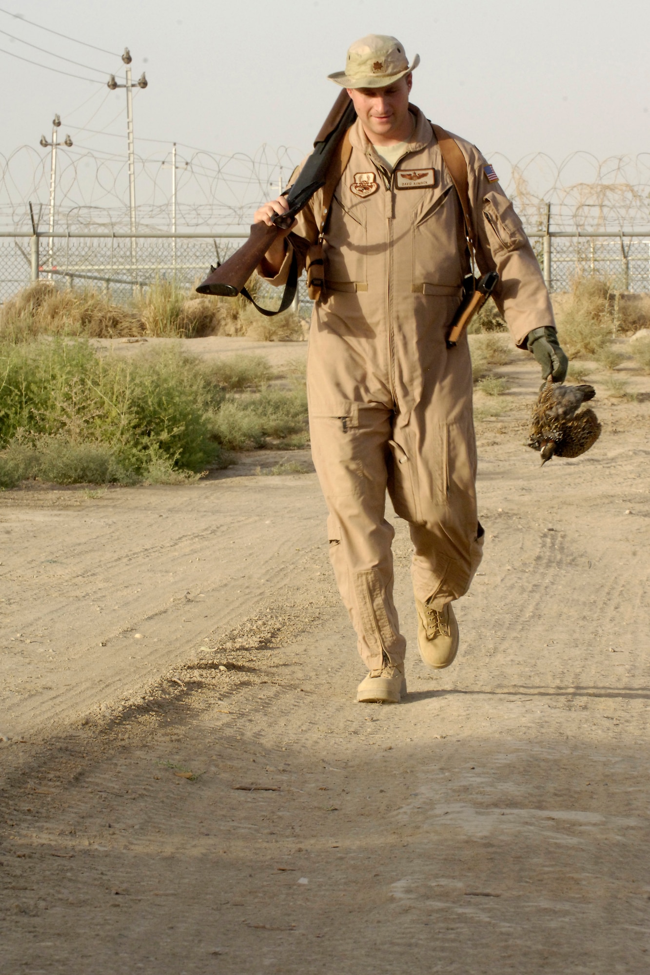 BAGHDAD INTERNATIONAL AIRPORT – Maj. David Aumack, 321st Air Expeditionary Wing Safety flight safety officer, brings in a quail he killed June 3 as part of the Bird/Wildlife Aircraft Strike Hazard program. Advisors from the Iraq Training and Advisory Mission – Air are planning to train the Iraqi air force on airfield management techniques, like the BASH program, in the coming months. (U.S. Air Force photo by Tech. Sgt. Randy Redman)