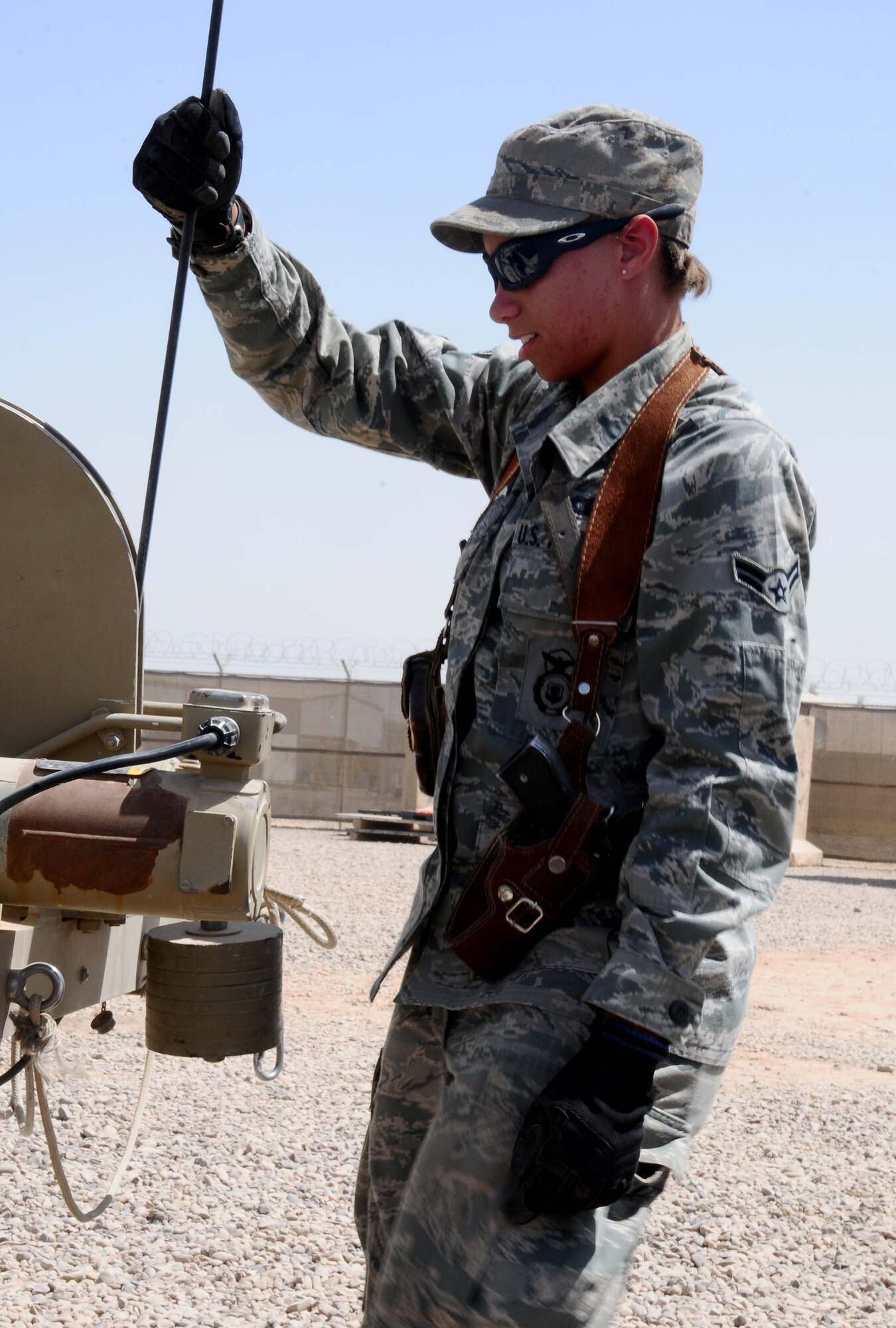 Airman 1st Class Ashley Thomas, 332nd Expeditionary Security Forces Squadron aerostat center line operator, assists with lowering the aerostat at Joint Base Balad. This was the first time an aerostat was launched at JBB and the first time it was operated by Airmen. The aerostat is an Army asset. (U.S. Air Force photo by Airman 1st Class Jeffrey Schultze) 