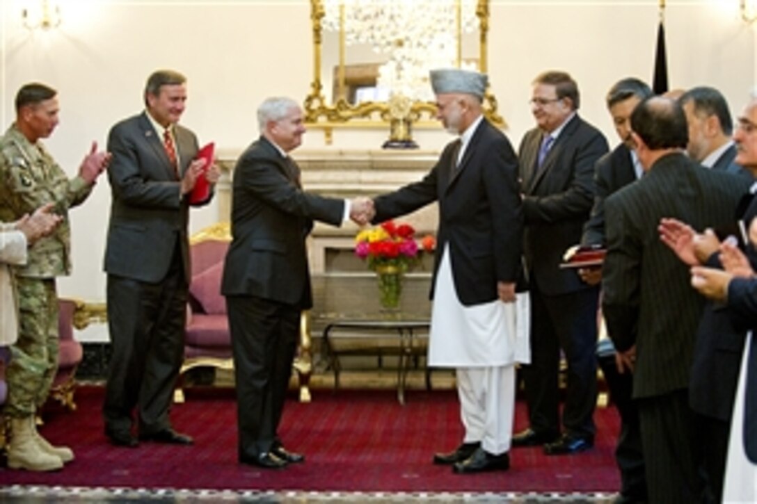Afghan President Hamid Karzai presents U.S. Defense Secretary Robert M. Gates with the Ghazi Wazir Mohammad Akbar Khan Medal, Afghanistan's highest governmental award in Kabul, Afghanistan, June 4, 2011.