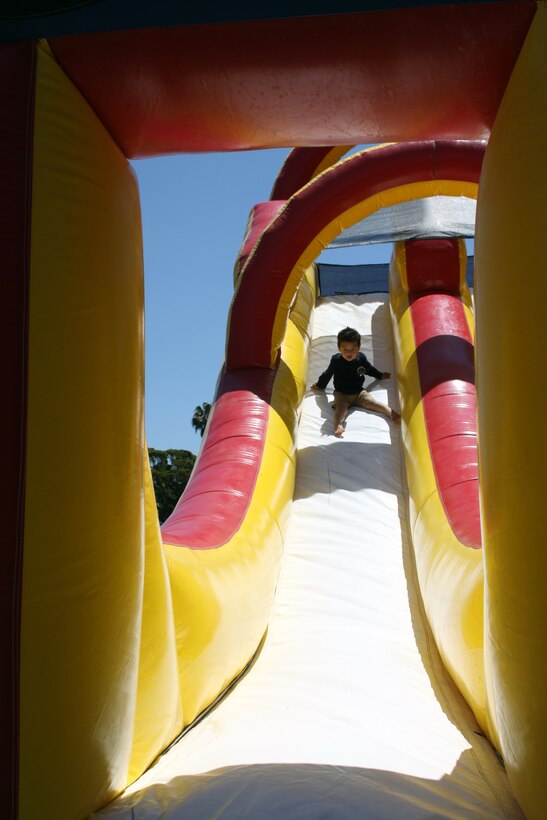 Dominic, 2, goes down the bounce slide June 4 at Summer Fest aboard Marine Corps Recruit Depot San Diego. Summer Fest provided activies and rides for children of all ages.