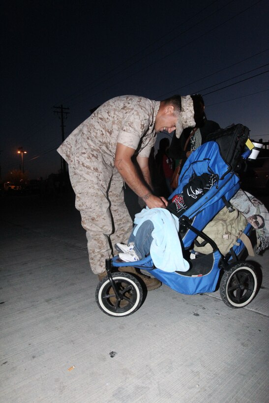 Sgt. Scott Rehm, machine gun squad leader Company G., 2nd Battalion, 7th Marine Regiment, plays with his two and a half year old son, Adrian, before departing for a seven-month deployment with the 31st Marine Expeditionary Unit June 5, 2011.
