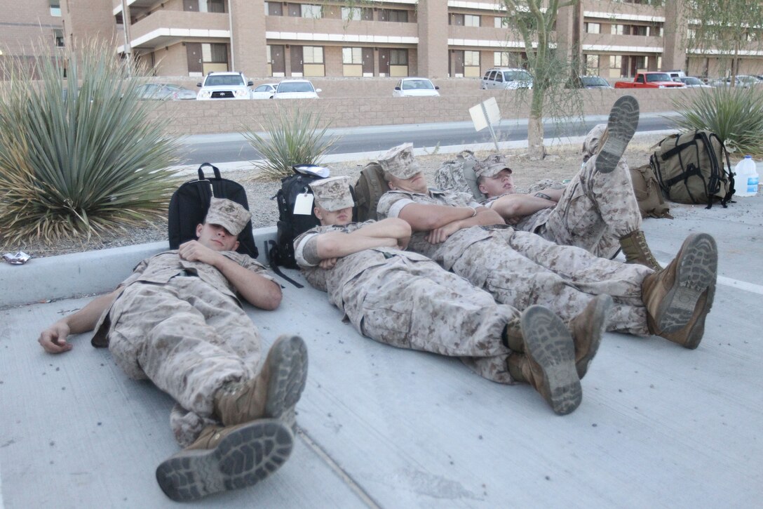 Marines with the Company G., 2nd Battalion, 7th Marine Regiment, take a small rest before the long flights to join the 31st Marine Expeditionary Unit May 5, 2011.::r::::n::