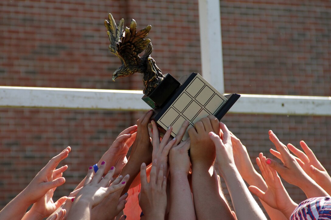 Players from the Armstrong Falcons raise the Girls Division 1 championship trophy after beating the Orono Nightmares 5-0 for the state title during the Minnesota Amateur Rugby Foundation Tournament at Gordy Aamoth Jr., Memorial Stadium June 5. For additional imagery from the event, visit www.facebook.com/rstwincities.