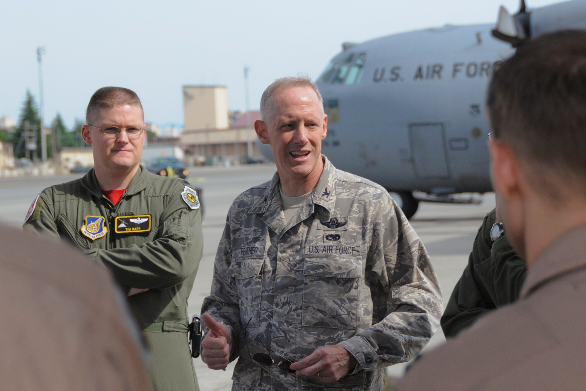 YOKOTA AIR BASE, Japan -- Col. Otto Feather, 374th Airlift Wing commander, talks to Airmen from the 36th Airlift Squadron prior to deploying from Yokota, June 3, 2011. Wing leadership, friends and family members came out to show support to members as they depart on a deployment to Southwest Asia. (U.S. Air Force photo/Airman John D. Partlow)