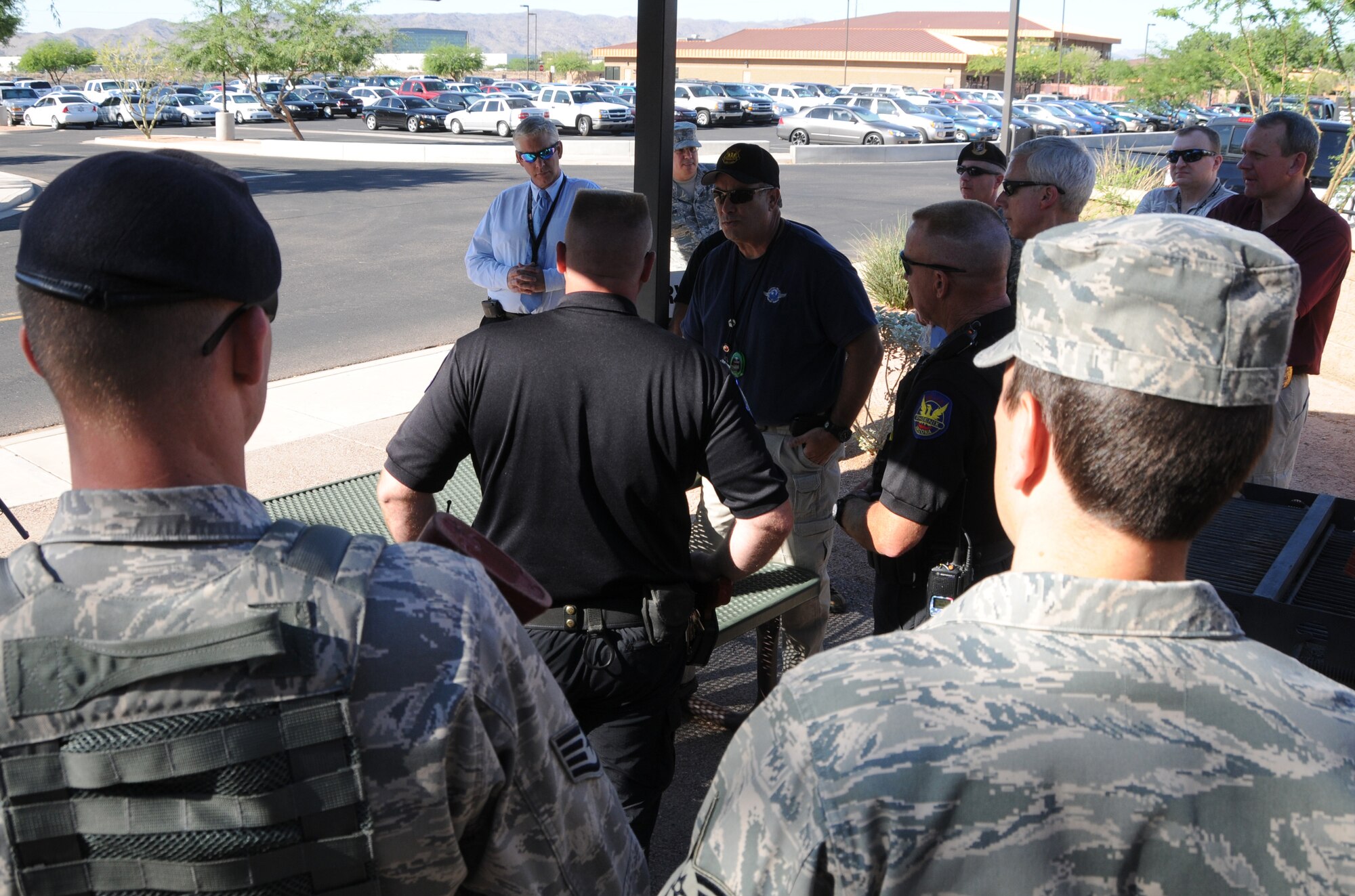 During an active shooter exercise, members of the Air National Guard, the Phoenix Police Department, the Federal Aviation Administration and the Transportation Security Agency work together to execute proper breaching and clearing techniques, at the 161st Air Refueling Guard base, Phoenix, June 4, 2011. This exercise helps to improve interagency communication and coordinate strategic planes. (U.S. Air Force photo by Staff Sgt. Courtney Enos/Released)