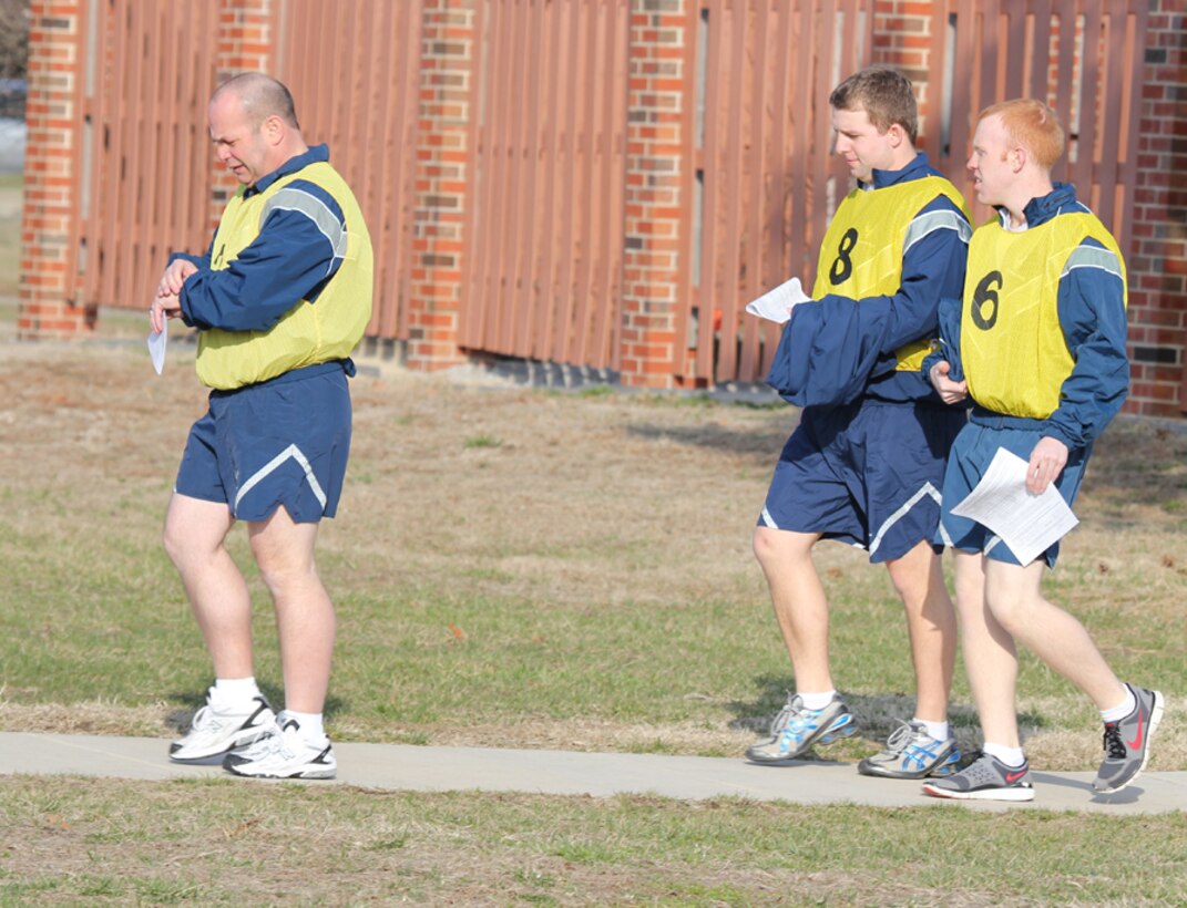 932nd Airlift Wing member Lt. Col. Andy Chancellor checks his stopwatch as he leads a group of Air Force Reserve Command reservists over to the Scott Air Force Base track for a fitness run.  Pushups, situps, and the run are emphasized throughout the year and encouraged with additional "fun" runs and practices on different drill weekends.  (U.S. Air Force photo/Maj. Stan Paregien)