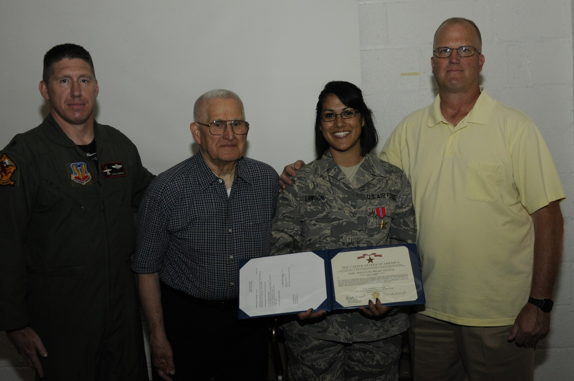 Technical Sgt. Supapon Lawson, an aircrew flight equipment specialist with the 107th Fighter Squadron, was awarded the Bronze Star Medal for exceptional meritorious service at a ceremony held at Selfridge Air National Guard Base on June 6. Lawson served as an aircrew life support technician during a deployment to Iraq in which she volunteered for several tour extensions, which lengthened her stay to almost two years. On hand during the medal presentation ceremony were Lt. Col. Douglas Champagne, 107th Fighter Squadron commander, TSgt. Lawson's grandfather and World War II veteran, Mr. Dick Lawson, and her father, Mr. Doug Lawson, a former Air Force security forces officer. (U.S. Air Force photo by TSgt. David Kujawa)