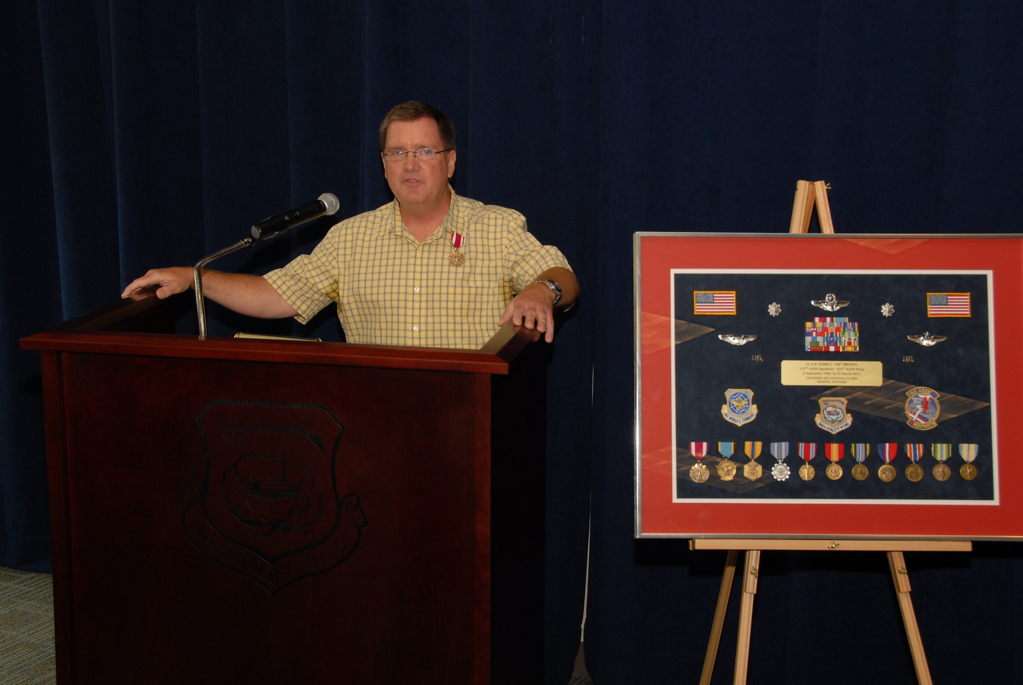 Mark E. Brown, retired Lieutenant Colonel, speaks to the crowd of his retirement ceremony, held June 4th, 2011, after being presented with a career shadow box.