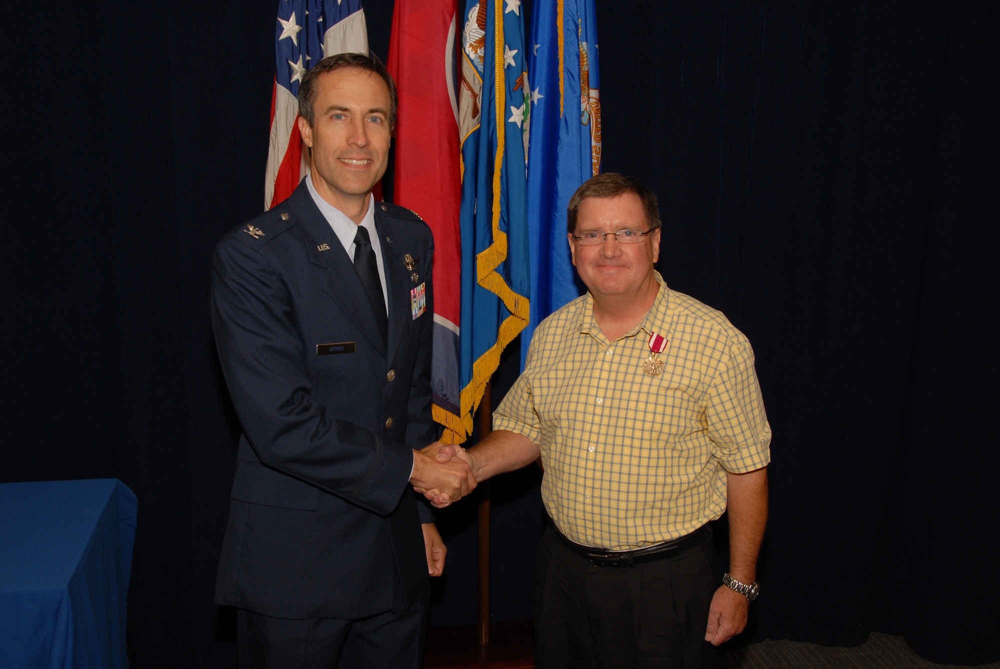 Mark E. Brown, retired Lieutenant Colonel, poses with Colonel Mark J. Devine, 164th Airlift Wing Vice Commander, after being awarded the Meritorious Service Medal during his retirement ceremony on June 4th, 2011.
