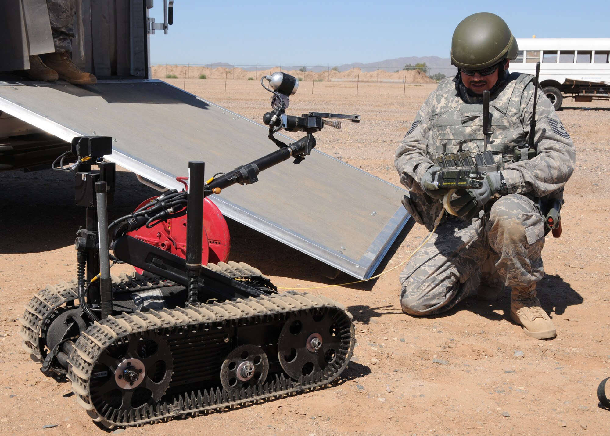 Tech. Sgt. Guy M. Gates, 944th Civil Engineer Squadron explosive ordinance device technician, prepares an explosive counter charge for the Talon robot to transport at the perimeter of the base.   The activities were part of an improvised explosive device training mission EOD participated in during the June UTA. (U.S. Air Force photo by Staff Sgt. Louis Vega Jr.)