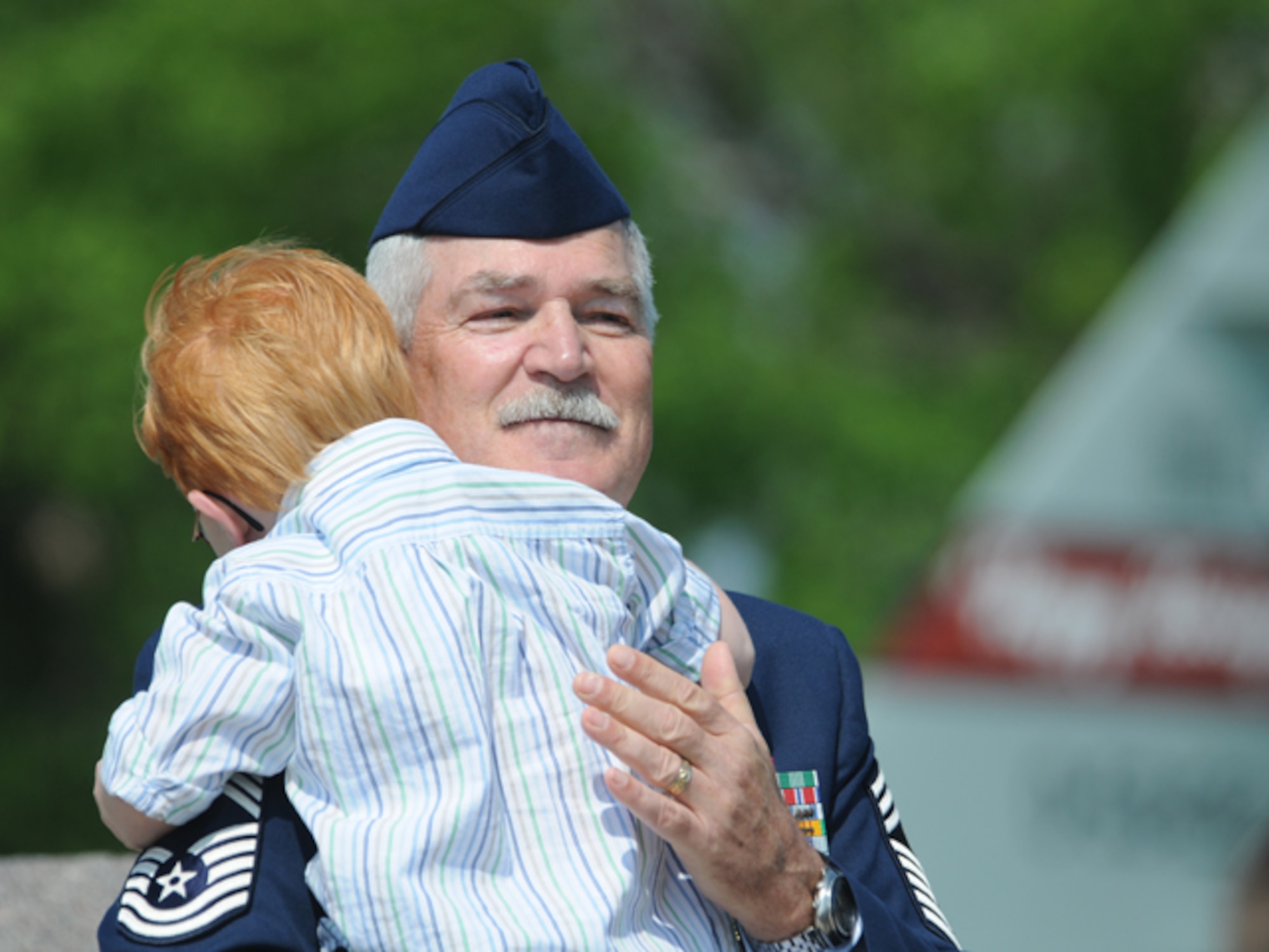 Chief Master Sgt. James Clemenson gives his grandson a hug June 4, during his retirement ceremony at the North Dakota Air National Guard, Fargo, N.D. Clemenson is the last enlisted Airman to have been stationed in Vietnam to retire from the Air Force.  Clemenson did two tours in Vietnam with the U.S. Army from October 1970 through April 1972. He joined the North Dakota Air National Guard in 1973 and has most recently served as the National Guard Bureau senior enlisted manager for the joint staff, Washington, D.C. He has served in the United States military for 41 years. Only one other active Airman, Chief Master Sgt. Jim Honeycutt, still remains in service that wears a Vietnam Service Ribbon, although it's for temporary duty in country versus a mobilization. Clemenson and Honeycutt's status is among active-duty Airmen and does not include drill status Guardsmen, on which no clear statistics were 
available.