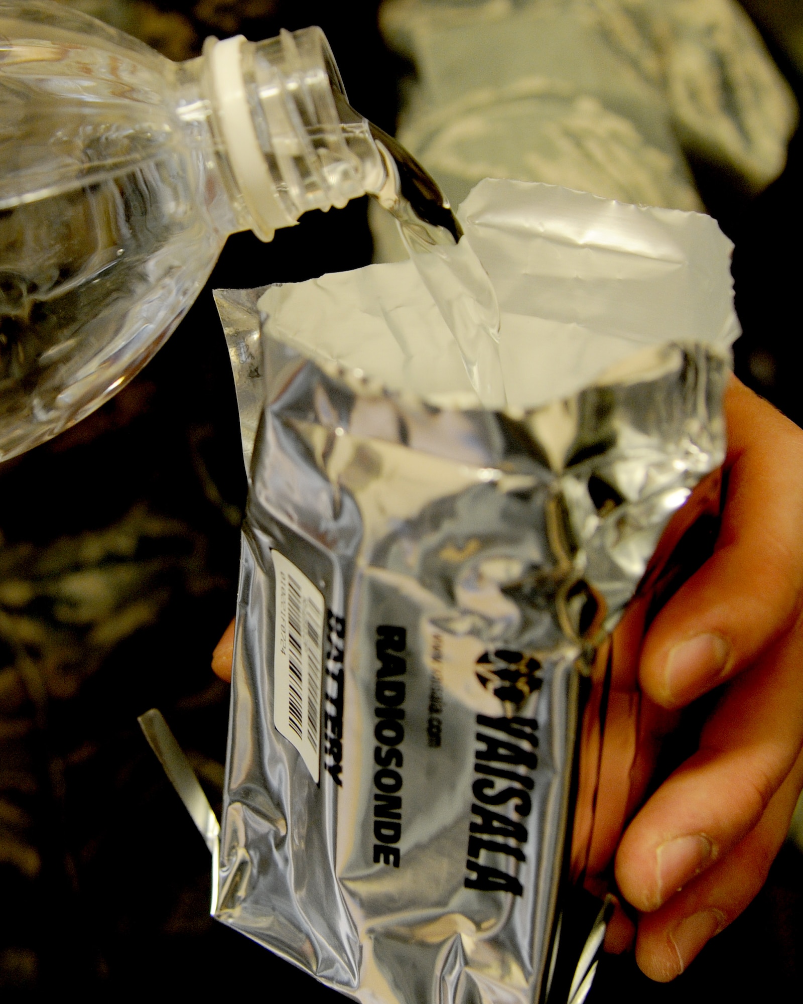 U.S. Air Force Staff Sgt. Casey Fletcher, 532nd Expeditionary Operations Support Squadron meteorologist fills the battery package for the radiosonde with water to help charge the battery at Al Asad Air Base, Iraq, May 28 2011. The batteries are used because the radiosonde cannot have any heavy metals in them because it falls back to land or the ocean and remains there. (U.S. Air Force photo by Senior Airman Tristin English)