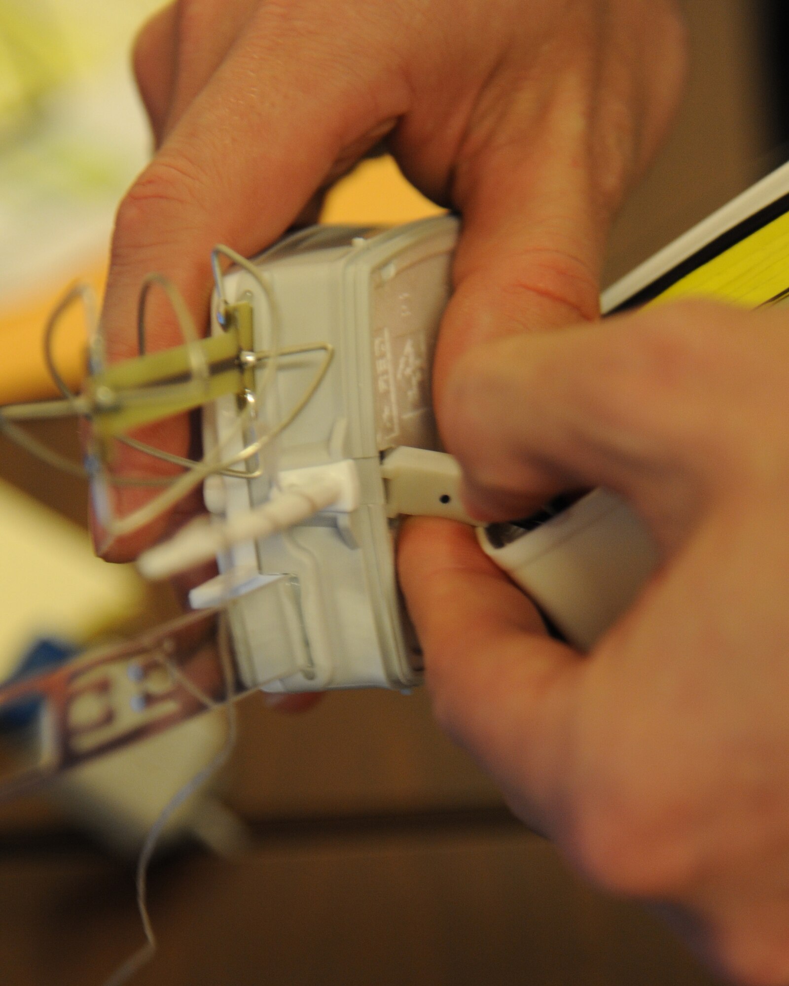 U.S. Air Force Staff Sgt. Casey Fletcher, 532nd Expeditionary Operations Support Squadron meteorologist connects the battery to a radiosonde at Al Asad Air Base, Iraq, May 27, 2011. The radiosonde is connected to a weather balloon and sent up into the air to track wind speed, pressure in the atmosphere, temperature and humidity. (U.S. Air Force photo by Senior Airman Tristin English)