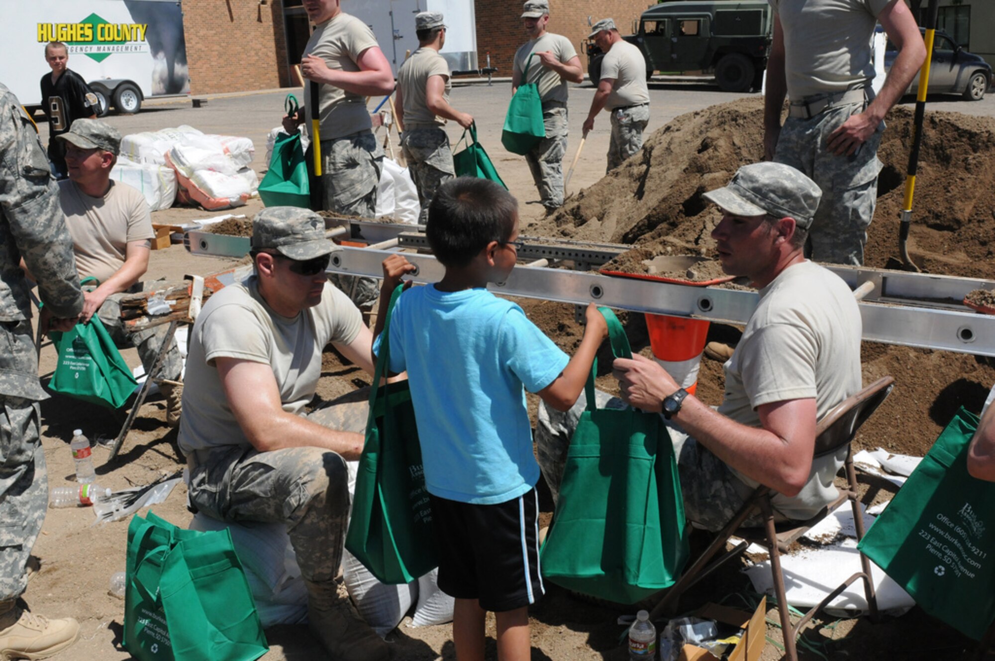 Children from the Children's Castle and East Side Day Care delivered bags of treats to Soldiers of the South Dakota National Guard filling sandbags at the Georgia Morse Middle School in Pierre, Friday, June 3, 2011. The children wanted to do something for the troops who have worked side-by-side with the Pierre community.  More than 1,150 Soldiers and Airmen of the South Dakota National Guard are currently on duty to help South Dakota citizens during this historic flood event occurring along the Missouri River. (SDNG photo by Master Sgt. Christopher Stewart) (RELEASED)