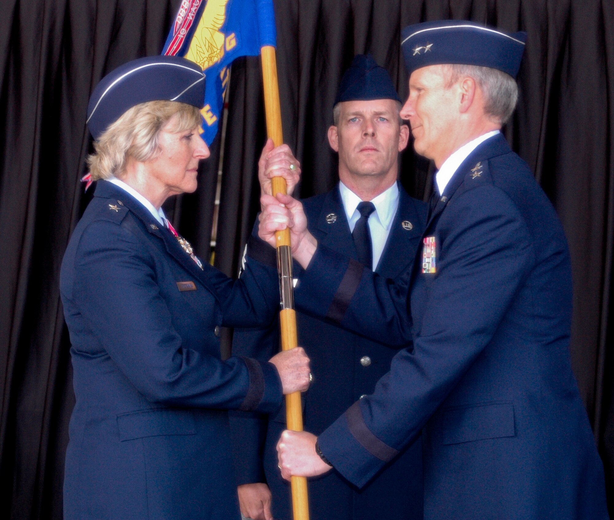 Brigadier General Carolyn J. Protzmann assumes command of the New Hampshire Air National Guard by accepting the Headquarters State NHANG guidon from Major General William N. Reddel III, Adjutant General, New Hampshire National Guard, Pease Air National Guard Base, NH, June 4, 2011.  Brigadier General Protzmann is the first female commander of the New Hampshire Air National Guard.  NH State Command Chief Master Sergeant Matthew Collier is the guidon bearer for the ceremony. (U.S. Air Force photo/Staff Sgt. Curtis J. Lenz)