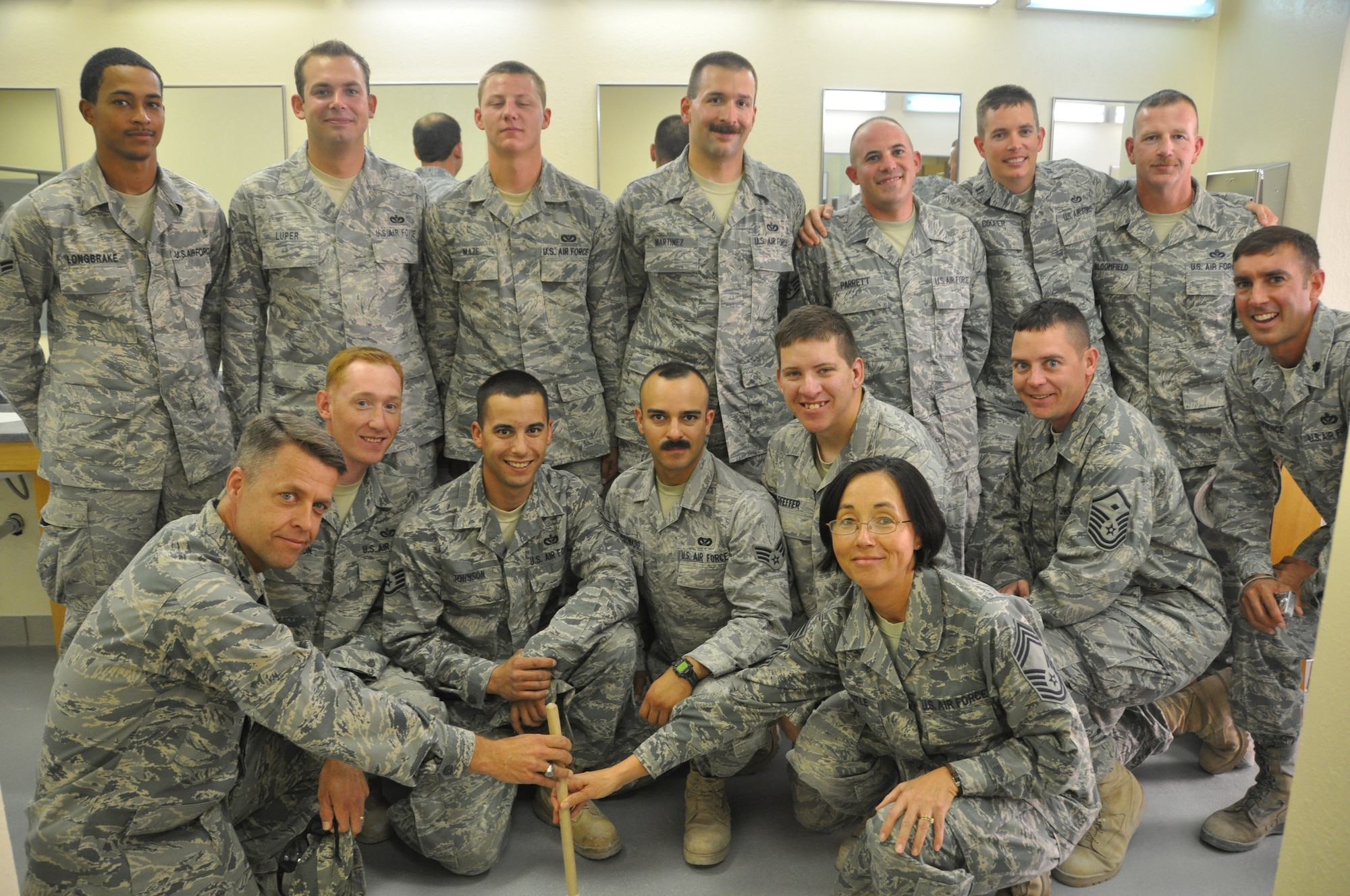 The 379th Civil Engineer Squadron ‘Tiger Team’ members join with 379th Expeditionary Mission Support Group leadership in opening the final bunker cadillac, completing another step to “Expeditionary to Enduring.”  (U.S. Air Force photo/Senior Airman Veronica McMahon)