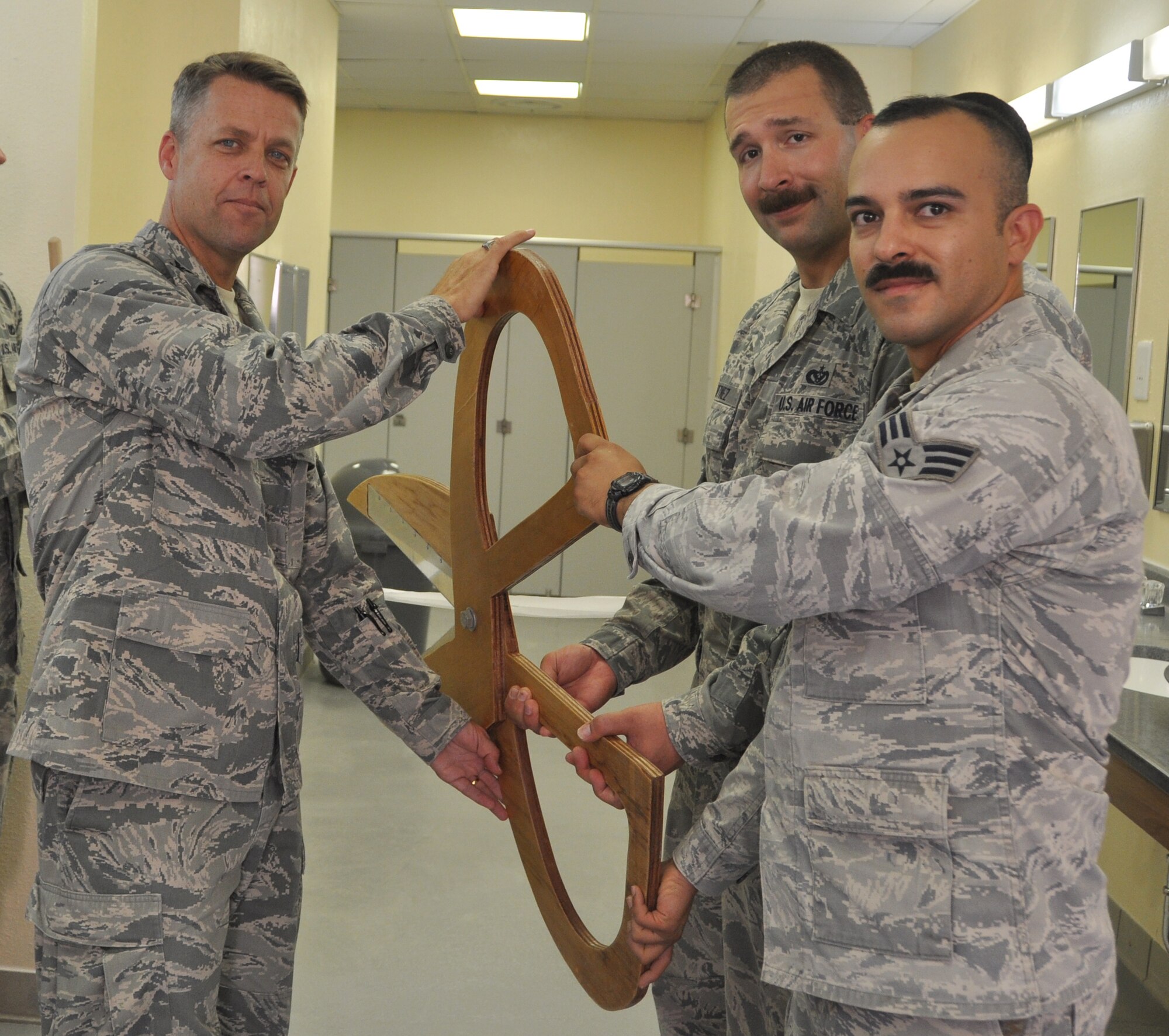 Col. James Pease, 379th Expeditionary Mission Support Group Commander, joins members of the 379th Civil Engineer Squadron ‘Tiger Team’, Senior Airman Esteban 
Maldonado and Staff Sgt. Robert Martinez, as they open the final bunker Cadillac, completing another step to “Expeditionary to Enduring.”  (U.S. Air Force photo/Senior Airman Veronica McMahon)
