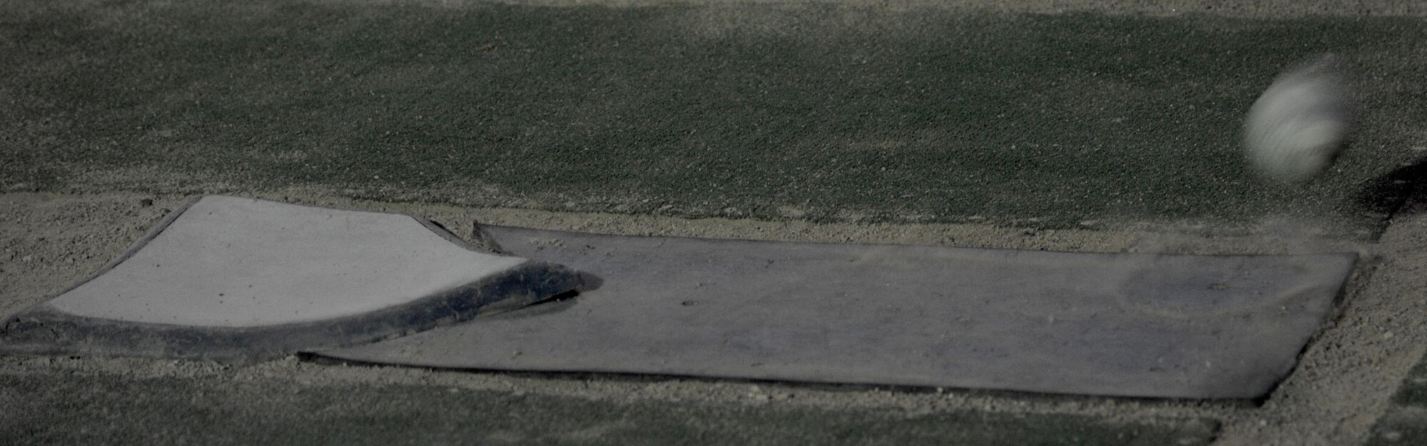 A softball falls for a strike during a game May 27, 2011, at Al Asad Air Base, Iraq. Airmen deployed to the 532nd Expeditionary Operations Support Squadron spearheaded construction of a softball field. The inspiration for the project came from two NCOs who watched the San Francisco Giants win the 2010 World Series. (U.S. Air Force photo by Senior Airman Tristin English)