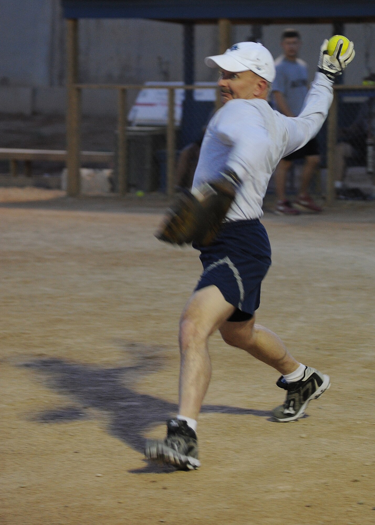 U.S. Air Force Lt. Col. Shawn Goodlett, 532nd Expeditionary Operations Support Squadron commander, warms up before playing a softball game May 27, 2011, at Al Asad Air Base, Iraq. His unit spearheaded construction of a softball field for the remotely located installation in western Al Anbar Province. (U.S. Air Force photo by Senior Airman Tristin English)