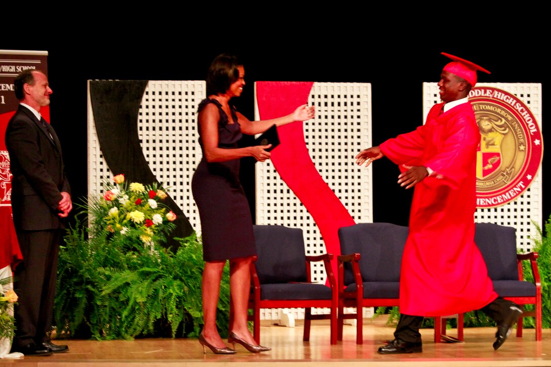 First Lady Michelle Obama and a 2011 graduate of Quantico Middle/High School prepare for a hug during commencement ceremonies on Marine Corps Base Quantico, June 3, 2011.