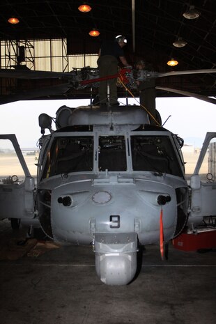 Two Helicopter Sea Combat Squadron 25 aviation electricians check the main rotor hub system of one of their MH-60S Knighthawk helicopters during a Phase D inspection at the HSC-25 hangar here June 6 .