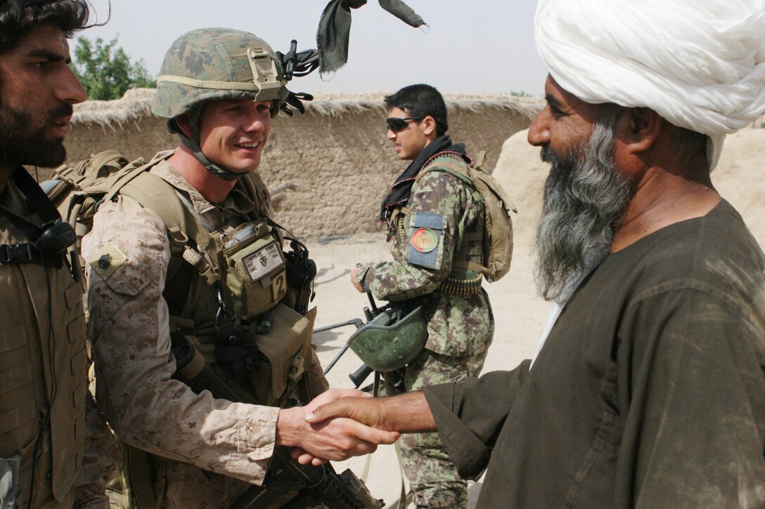 Staff Sgt. Justin B. Clemens, a native of Kansas City, Miss., greets a local man during Operation Maneuver One in the Village of Ghughori Baba within Sangin, Afghanistan, June 5. The district of Sangin is located Clemens talked to the man to learn about the town, the security of the village and what the village lacked as it is secluded between the mountains and the Helmand River. “Ultimately what this fight comes down to are the people,” said Clemens, the platoon sergeant for 1st Platoon, Company B, 1st Battalion, 5th Marine Regiment. “We are here to protect the people and provide security.”