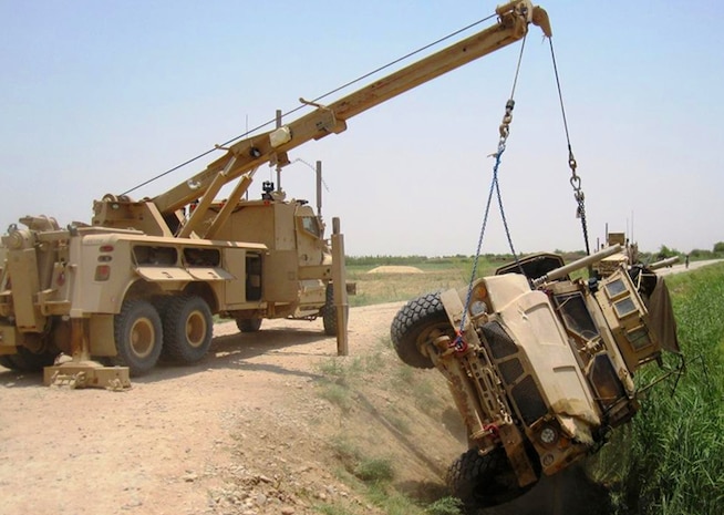 A Mine Resistant Ambush Protected (MRAP) Recovery Vehicle (left) recovers an MRAP All-Terrain Vehicle