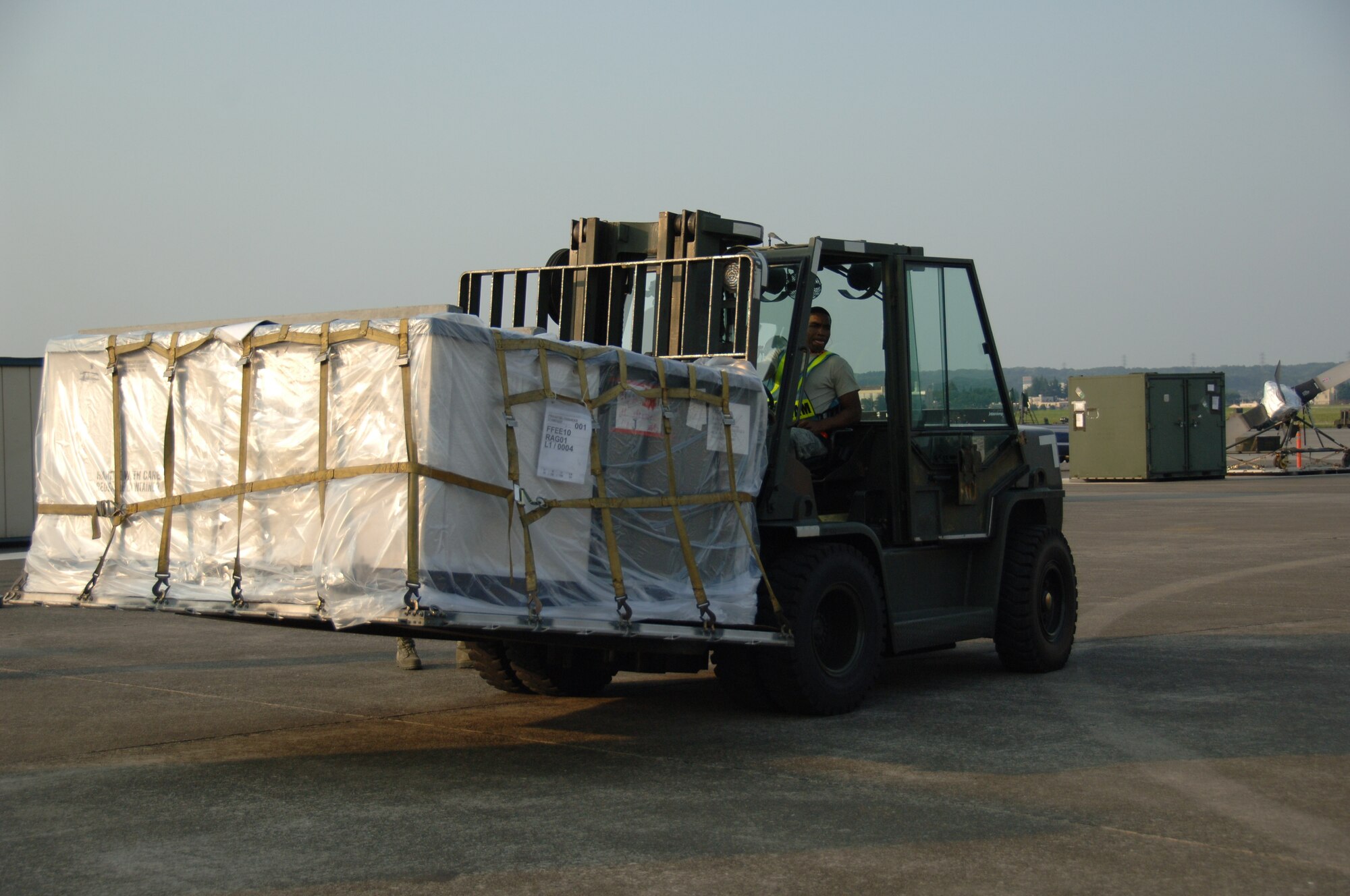 YOKOTA AIR BASE, Japan -- Senior Airman Darnell Strawder, 374th Maintenance Squadron unloads cargo during an Initial Readiness Response Exercise at Yokota Air Base, Japan, June 7, 2011. The goal of the exercise is to test Yokota's ability to respond appropriately and effectively to real world disasters. (U.S. Air Force photo/Airman 1st Class Lynsie Nichols) 