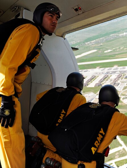 Members of the U.S. Army Golden Knights Parachute Team prepare to jump as they fly over the 2011 Dakota Thunder airshow at Ellsworth Air Force Base, S.D., June 4, 2011. Meticulous rehearsals prior to their performances help the team maintain their excellent accuracy. (U.S. Air Force photo/Staff Sgt. Marc I. Lane)