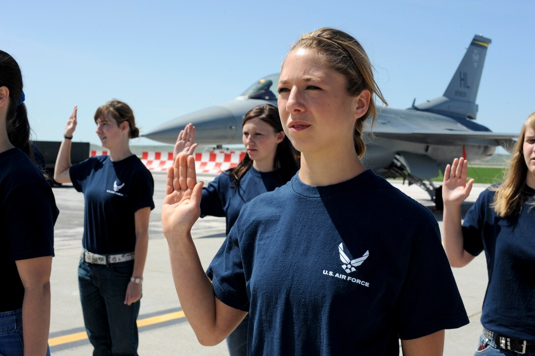 Members of the delayed enlistment program raise their right hands and take the Oath of Enlistment during the 2011 Dakota Thunder airshow at Ellsworth Air Force Base, S.D., June 4, 2011. The event drew in nearly 40, 000 people. (U.S. Air Force photo/Senior Airman Adam Grant)