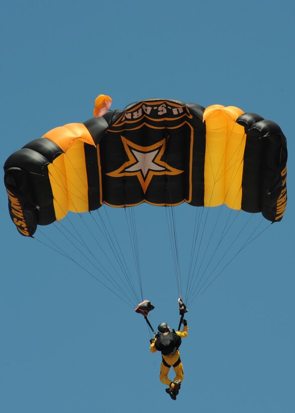 A member of the U.S. Army Golden Knights Parachute Team prepares to land during the 2011 Dakota Thunder airshow at Ellsworth Air Force Base, S.D., June 4, 2011. In the last three years alone, the competition teams have earned 27 gold medals, 93 silver medals, and 71 bronze medals in parachuting competitions.  (U.S. Air Force photo/Senior Airman Adam Grant)