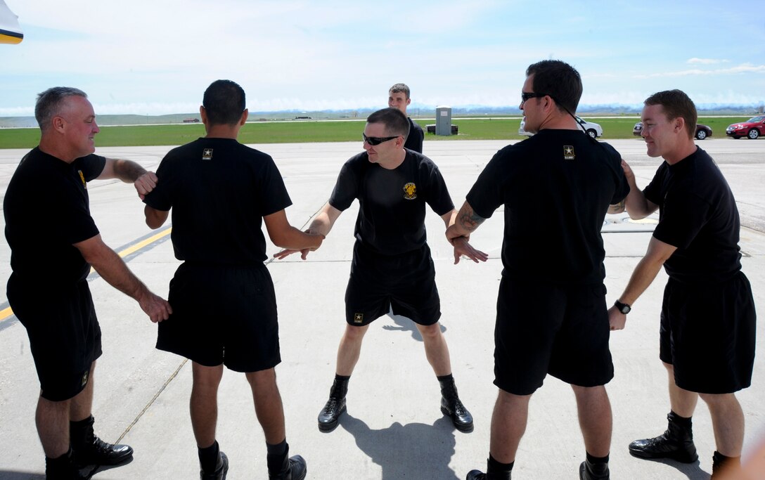 Members of the U.S. Army Golden Knights Parachute Team run through their performance at the 2011 Dakota Thunder airshow at Ellsworth Air Force Base, S.D., June 4, 2011. Meticulous rehearsals prior to their performances help the team maintain their high rates of accuracy.  (U.S. Air Force photo/Senior Airman Adam Grant)