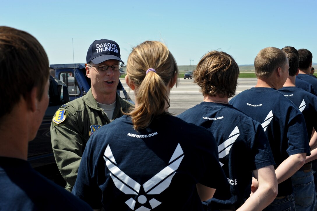 Col. Mark Weatherington, 28th Bomb Wing commander, congratulates members of the delayed enlistment program following their Oath of Enlistment during the 2011 Dakota Thunder airshow at Ellsworth Air Force Base, S.D., June 4, 2011. (U.S. Air Force photo/Senior Airman Adam Grant)
