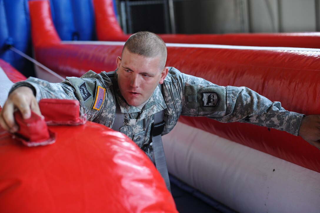 U.S. Army Sgt. Tyler Jacob, 235th Military Police Company military police, demonstrates the bungee run at the 2011 Dakota Thunder airshow at Ellsworth Air Force Base, S.D., June 4, 2011. The bungee run tests individual muscular leg strength and overall coordination.  (U.S. Air Force photo/Senior Airman Adam Grant)