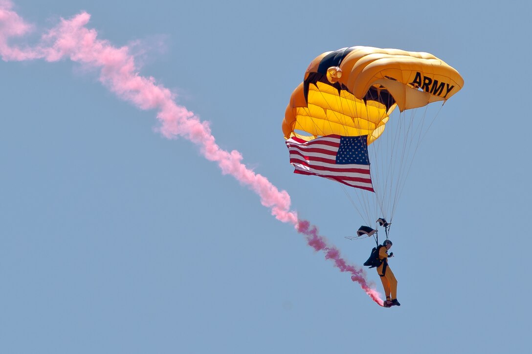 A U.S. Army Golden Knights parachutes team member soars above the crowd attending the 2011 Dakota Thunder airshow at Ellsworth Air Force Base, S.D., June 4, 2011. Nearly 40,000 people of all ages and walks of life converged here to watch the vast array of aerial demonstrations and view numerous static aircraft. (U.S. Air Force photo/Tech. Sgt. Nathan Gallahan)