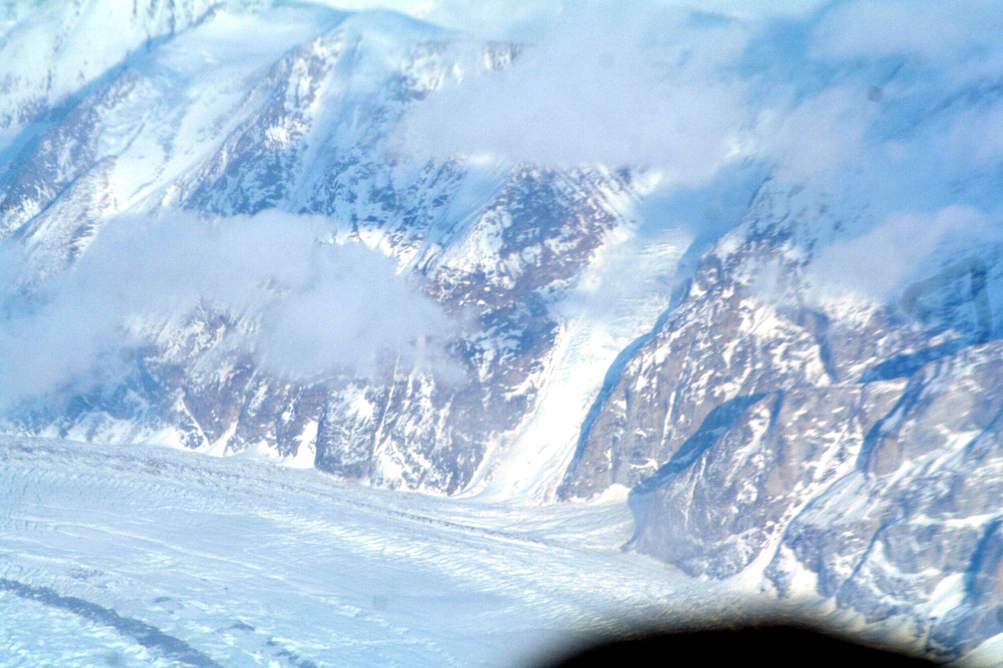 Ice-covered areas are seen from above the Arctic Circle from the window of a C-5M Super Galaxy on a  mission from Dover Air Force Base, Del., on June 5, 2011. The C-5M's mission was to complete the first Arctic overflight from Dover AFB to Bagram Airfield, Afghanistan. The plane successfully landed at Bagram just over 15 hours later on June 6, 2011. (U.S. Air Force Photo/Master Sgt. Scott T. Sturkol)